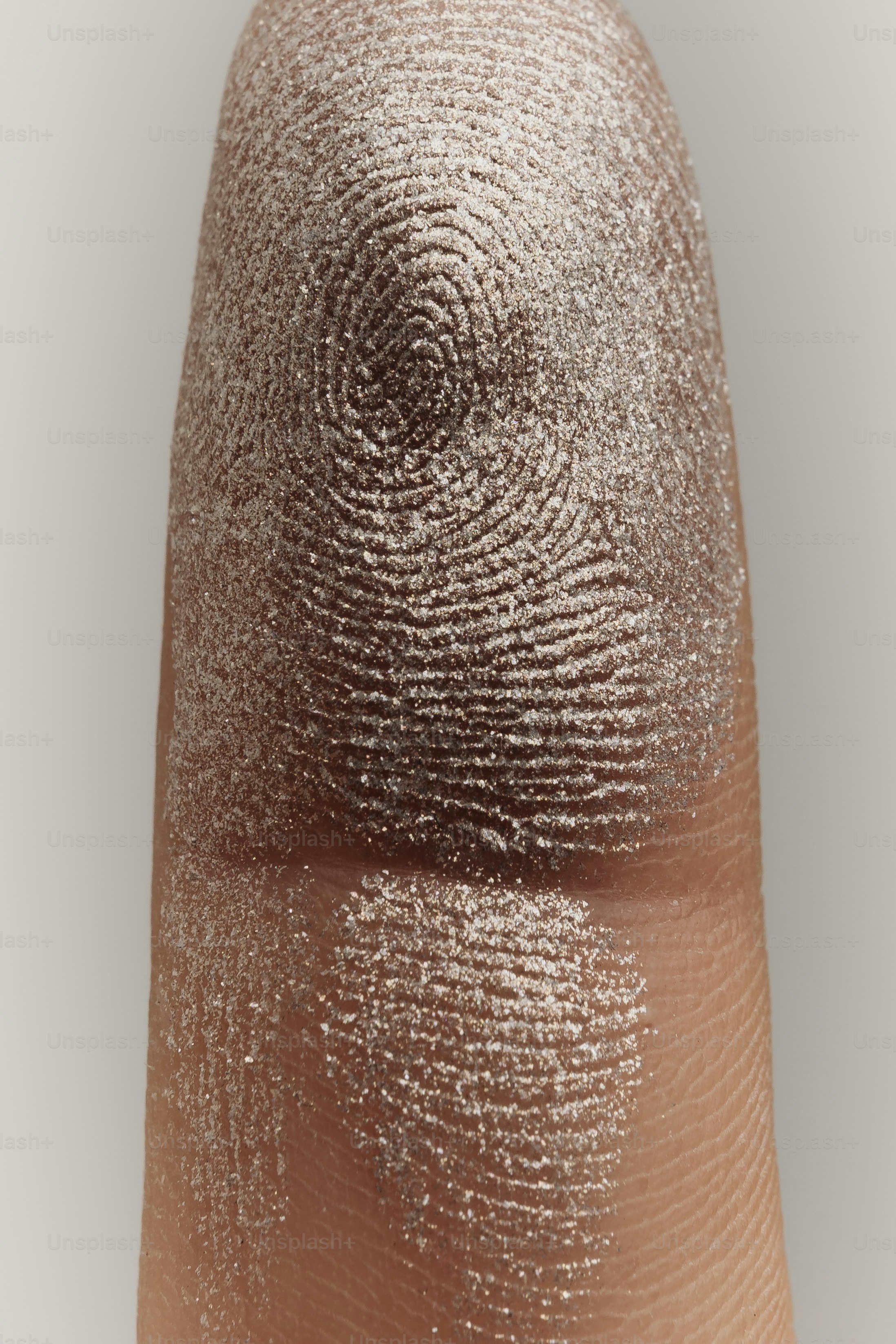 Close-up of a finger with fingerprint and glitter
